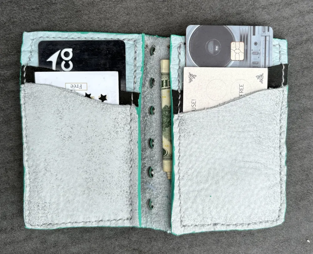 Wallet opened flat and full of example credit cards